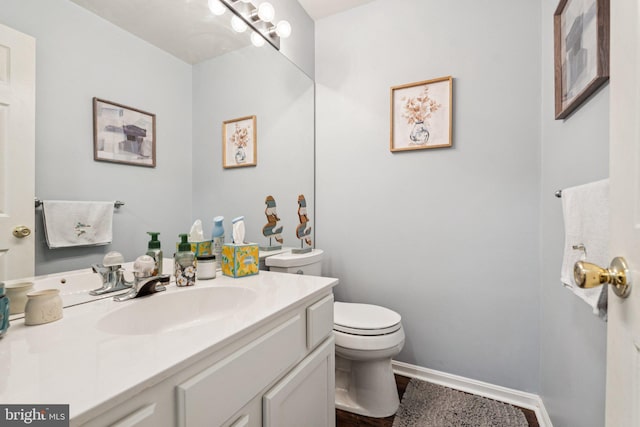 11193 Rienzi Pl Unit 203, Manassas, VA 20109 - bathroom featuring toilet, vanity, and baseboards