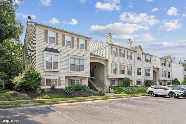 11193 Rienzi Pl Unit 203, Manassas, VA 20109 - view of property featuring uncovered parking, stairs, and a residential view