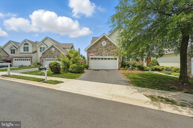 19885 Naples Lakes Ter, Ashburn, VA 20147 - view of front facade with stone siding, driveway, a garage, and a front yard