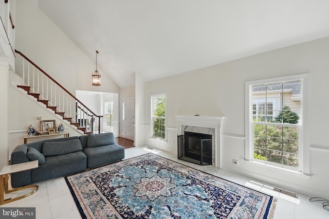 19885 Naples Lakes Ter, Ashburn, VA 20147 - living room with stairway, a premium fireplace, and high vaulted ceiling