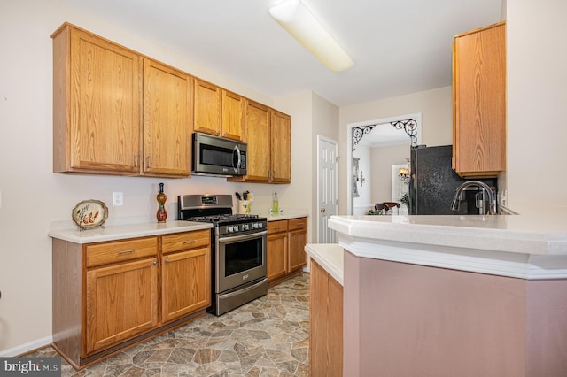 4784 Wermuth Way, Woodbridge, VA 22192 - kitchen with appliances with stainless steel finishes, light countertops, light stone finish flooring, and a peninsula