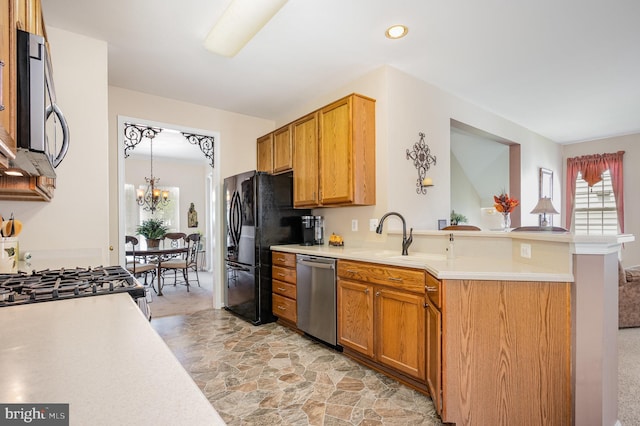 4784 Wermuth Way, Woodbridge, VA 22192 - kitchen featuring appliances with stainless steel finishes, a sink, light countertops, light stone finish floors, and a chandelier