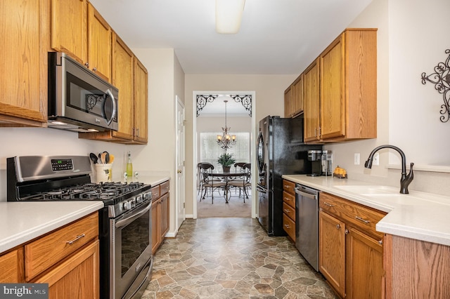 4784 Wermuth Way, Woodbridge, VA 22192 - kitchen with appliances with stainless steel finishes, a sink, light countertops, a chandelier, and stone finish flooring