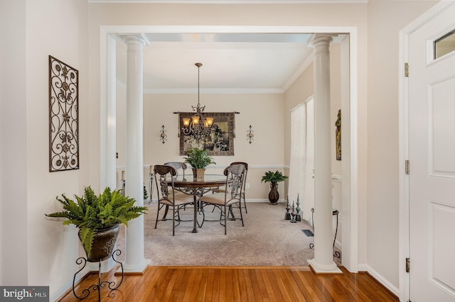 4784 Wermuth Way, Woodbridge, VA 22192 - dining area featuring wood finished floors, crown molding, a chandelier, baseboards, and decorative columns