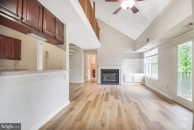 4100 Monument Ct Unit 302, Fairfax, VA 22033 - unfurnished living room with ceiling fan, light wood-style floors, baseboards, a fireplace with flush hearth, and high vaulted ceiling
