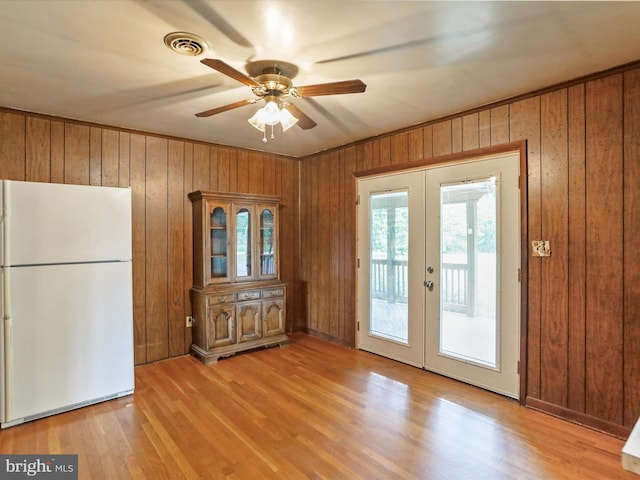 193 Chevy Ln, Berkeley Springs, WV 25411 - doorway featuring french doors, a ceiling fan, wooden walls, and light wood-style flooring
