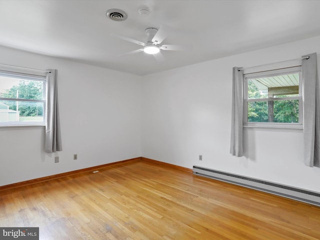 193 Chevy Ln, Berkeley Springs, WV 25411 - spare room featuring light wood finished floors, baseboard heating, ceiling fan, and baseboards