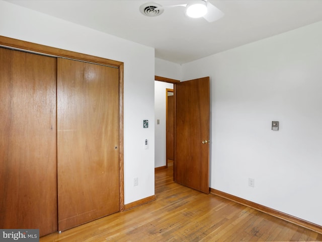 193 Chevy Ln, Berkeley Springs, WV 25411 - unfurnished bedroom with a closet, light wood-style flooring, baseboards, and a ceiling fan