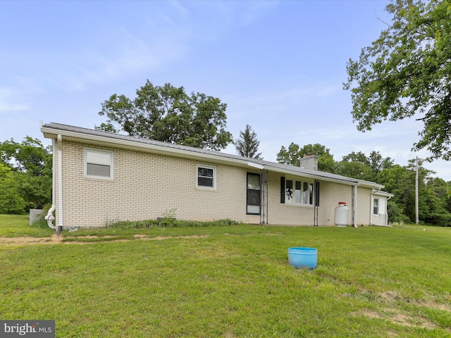 193 Chevy Ln, Berkeley Springs, WV 25411 - view of front of home with a front yard, brick siding, and a chimney