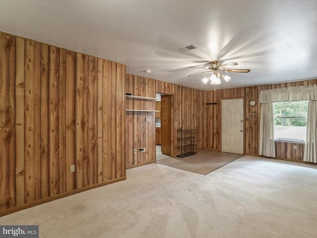193 Chevy Ln, Berkeley Springs, WV 25411 - unfurnished living room featuring wooden walls, light colored carpet, and a ceiling fan