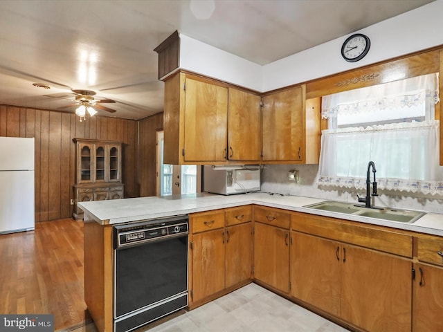 193 Chevy Ln, Berkeley Springs, WV 25411 - kitchen with freestanding refrigerator, dishwasher, a sink, light countertops, and wood walls