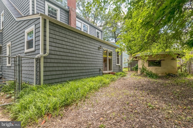 722 Kennebec Ave, Takoma Park, MD 20912 - view of side of property with a chimney and a gate