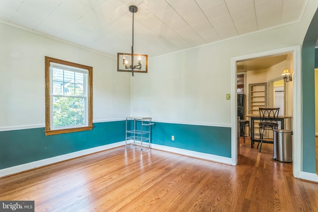 722 Kennebec Ave, Takoma Park, MD 20912 - spare room featuring ornamental molding, a chandelier, wood finished floors, and baseboards