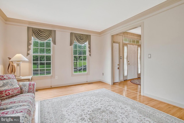 927 Brick Manor Cir, Silver Spring, MD 20905 - living area featuring wood finished floors, healthy amount of natural light, baseboards, and crown molding