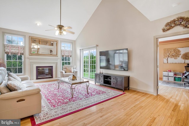 927 Brick Manor Cir, Silver Spring, MD 20905 - living room with wood-type flooring, high vaulted ceiling, ceiling fan, a glass covered fireplace, and baseboards