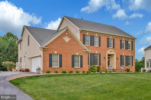 927 Brick Manor Cir, Silver Spring, MD 20905 - view of front of home featuring brick siding, asphalt driveway, a front lawn, and a garage