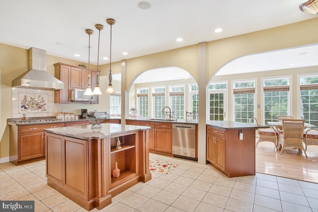 927 Brick Manor Cir, Silver Spring, MD 20905 - kitchen with wall chimney exhaust hood, stainless steel appliances, a sink, brown cabinets, and recessed lighting