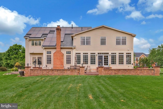 927 Brick Manor Cir, Silver Spring, MD 20905 - rear view of property with a patio, solar panels, a yard, and roof with shingles
