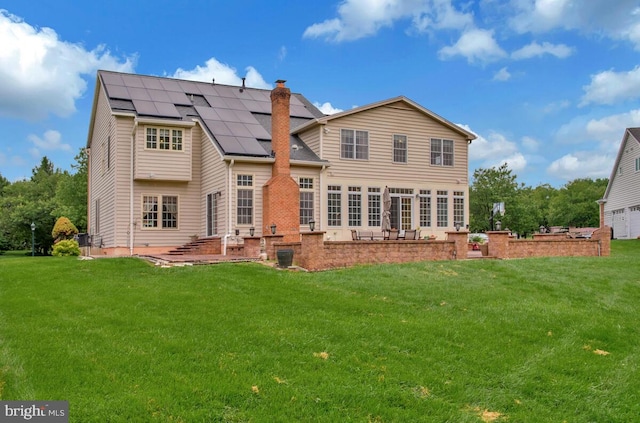 927 Brick Manor Cir, Silver Spring, MD 20905 - rear view of house featuring a yard, roof mounted solar panels, a patio, and a chimney