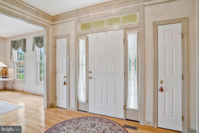 927 Brick Manor Cir, Silver Spring, MD 20905 - entrance foyer with light wood finished floors, baseboards, and ornamental molding