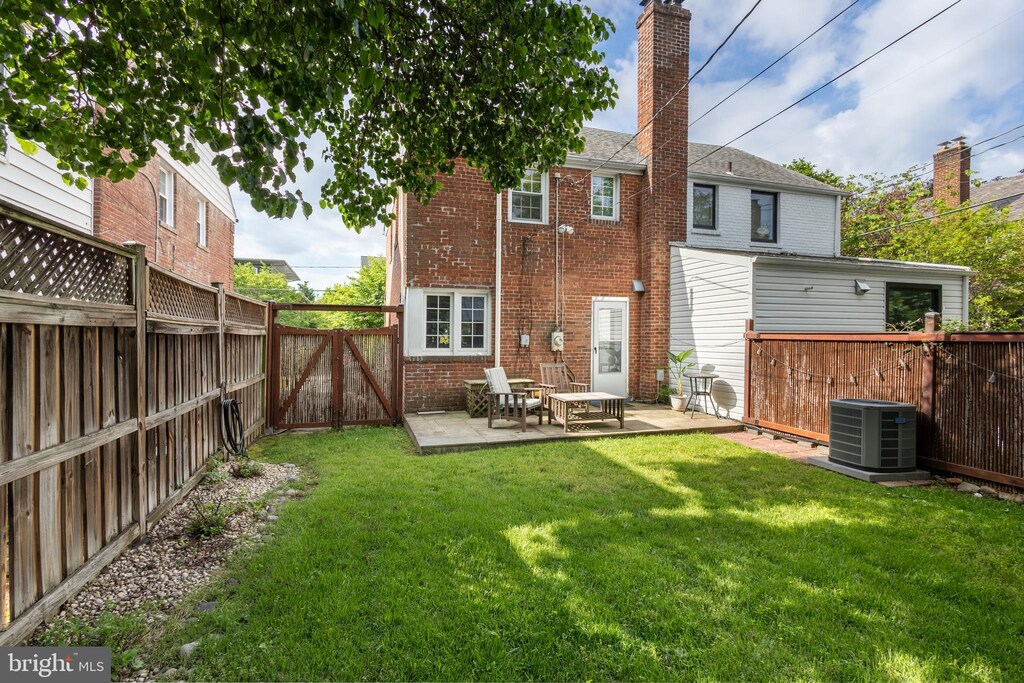 3731 6th Rd N, Arlington, VA 22203 - back of house featuring brick siding, central AC unit, a chimney, and a patio