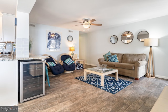 183 Jamestown Rd Unit 10, Ocean City, MD 21842 - living area featuring beverage cooler, wet bar, a ceiling fan, wood finished floors, and baseboards