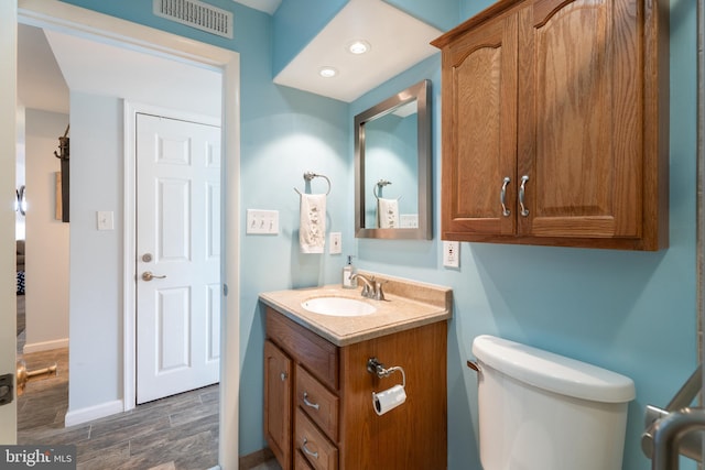 183 Jamestown Rd Unit 10, Ocean City, MD 21842 - bathroom featuring vanity, wood finished floors, toilet, baseboards, and recessed lighting