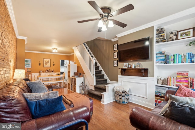 2326 E Boston St, Philadelphia, PA 19125 - living room featuring stairs, a ceiling fan, wood finished floors, crown molding, and built in shelves