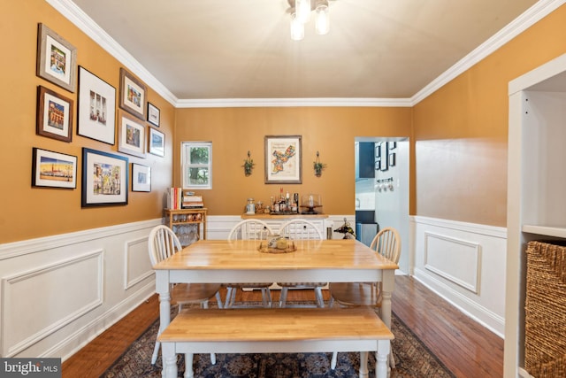2326 E Boston St, Philadelphia, PA 19125 - dining space with wood finished floors, crown molding, a decorative wall, and a wainscoted wall