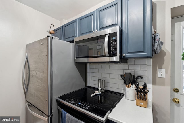 2326 E Boston St, Philadelphia, PA 19125 - kitchen with stainless steel microwave, black range with electric stovetop, tasteful backsplash, and blue cabinets