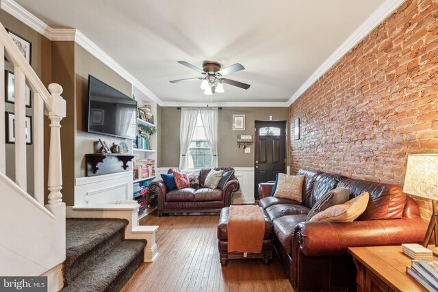 2326 E Boston St, Philadelphia, PA 19125 - living room featuring crown molding, stairs, a ceiling fan, wood-type flooring, and a wainscoted wall