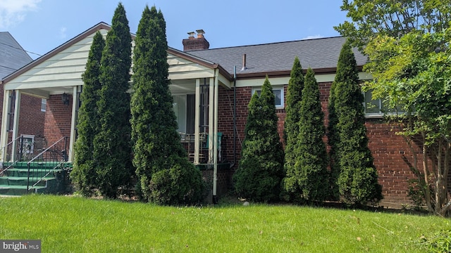 1611 Parham Rd, Silver Spring, MD 20903 - view of home's exterior with brick siding, a chimney, and a yard