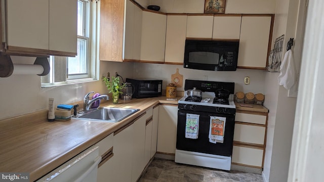 1611 Parham Rd, Silver Spring, MD 20903 - kitchen with black microwave, stove, a sink, and light countertops