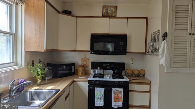 1611 Parham Rd, Silver Spring, MD 20903 - kitchen featuring black microwave, gas stove, a sink, and healthy amount of natural light