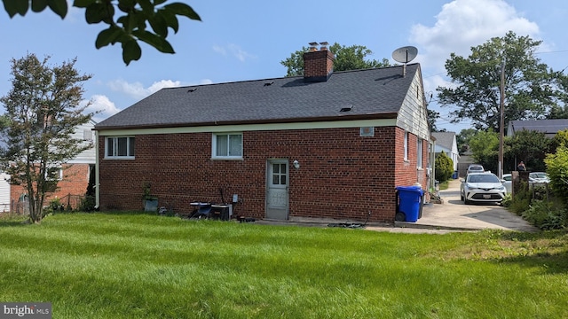 1611 Parham Rd, Silver Spring, MD 20903 - back of house with brick siding, a chimney, and roof with shingles