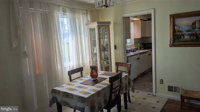 1611 Parham Rd, Silver Spring, MD 20903 - dining area featuring healthy amount of natural light, ornamental molding, a chandelier, and baseboards