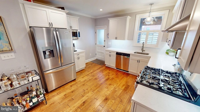 2714 Fait Ave, Baltimore, MD 21224 - kitchen with stainless steel appliances, a sink, light countertops, white cabinetry, and ornamental molding