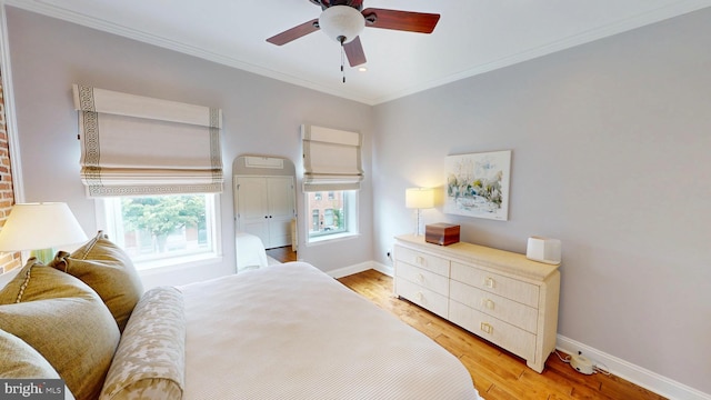 2714 Fait Ave, Baltimore, MD 21224 - bedroom with baseboards, light wood-style floors, crown molding, and a ceiling fan