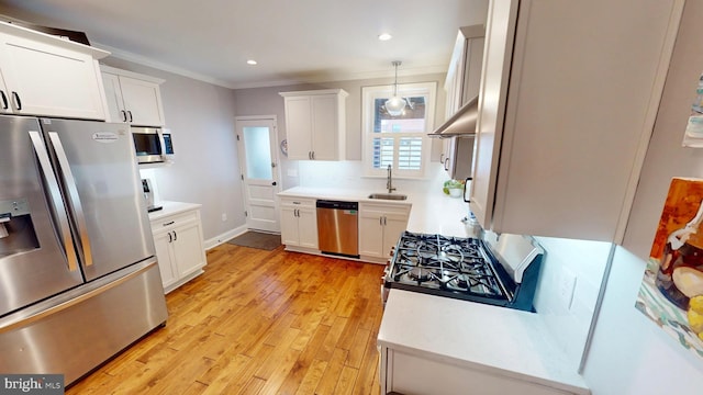 2714 Fait Ave, Baltimore, MD 21224 - kitchen featuring stainless steel appliances, a sink, ornamental molding, under cabinet range hood, and white cabinetry
