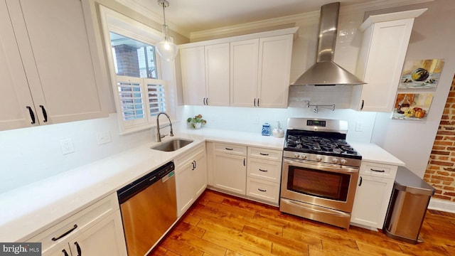 2714 Fait Ave, Baltimore, MD 21224 - kitchen featuring wall chimney range hood, stainless steel appliances, a sink, light wood-style flooring, and white cabinetry