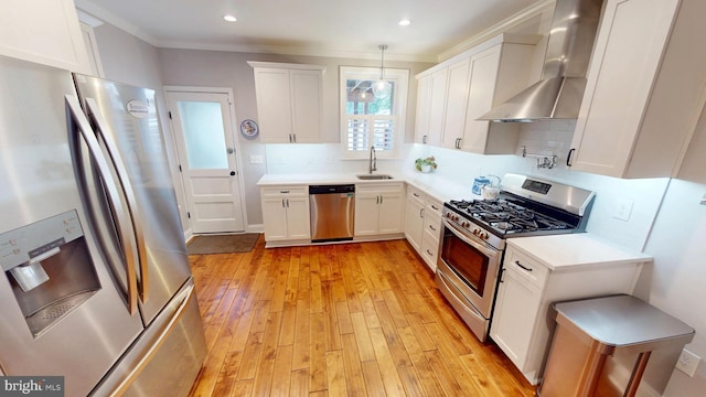 2714 Fait Ave, Baltimore, MD 21224 - kitchen featuring stainless steel appliances, wall chimney exhaust hood, a sink, light wood-style floors, and backsplash