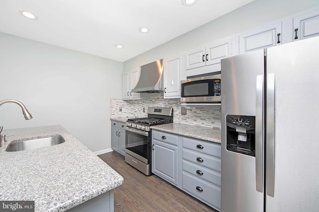 13 Briarcliff Rd, Marlton, NJ 08053 - kitchen with appliances with stainless steel finishes, wall chimney exhaust hood, a sink, tasteful backsplash, and dark wood-style flooring