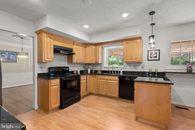 17220 Larosa Dr, Rockville, MD 20855 - kitchen featuring black appliances, under cabinet range hood, a sink, light wood-style flooring, and dark stone counters