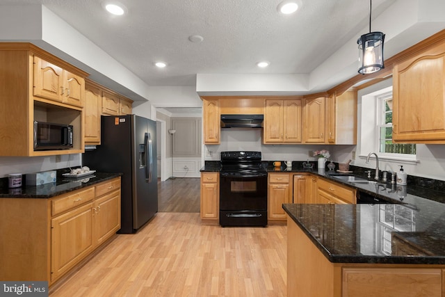 17220 Larosa Dr, Rockville, MD 20855 - kitchen with black appliances, under cabinet range hood, a sink, light wood-type flooring, and dark stone countertops