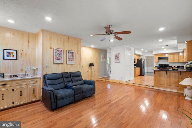 17220 Larosa Dr, Rockville, MD 20855 - living area featuring a ceiling fan, light wood-style flooring, recessed lighting, wooden walls, and baseboards