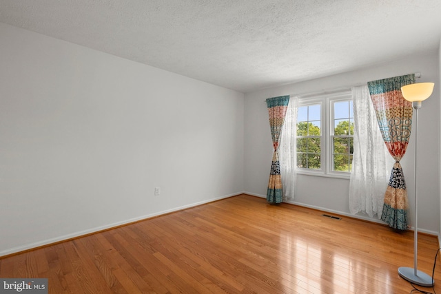 17220 Larosa Dr, Rockville, MD 20855 - unfurnished room with wood finished floors, baseboards, and a textured ceiling