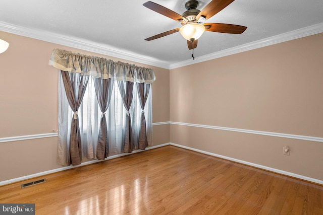 17220 Larosa Dr, Rockville, MD 20855 - unfurnished room with baseboards, wood finished floors, a ceiling fan, and crown molding