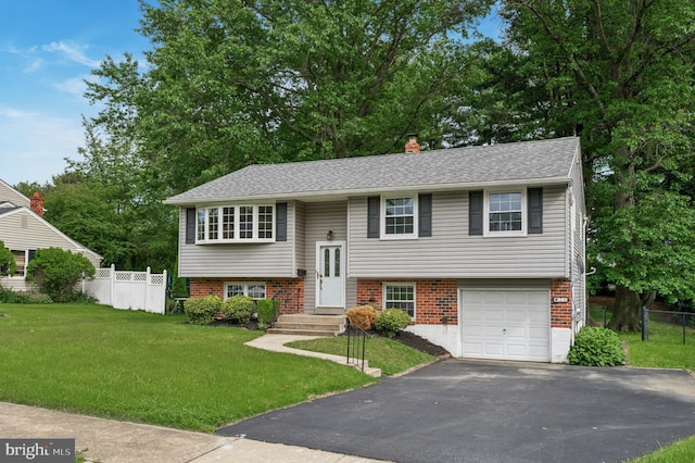 26 Anvil Rd, Aston, PA 19014 - bi-level home with an attached garage, driveway, and brick siding