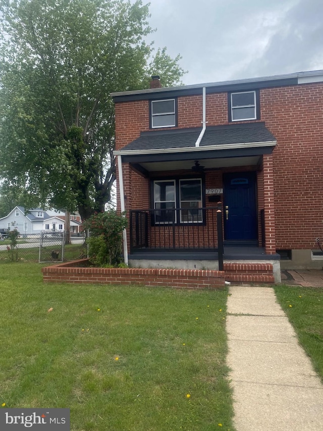 7907 Wallace Rd, Dundalk, MD 21222 - townhome / multi-family property with brick siding, a porch, and a chimney
