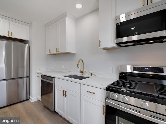 7907 Wallace Rd, Dundalk, MD 21222 - kitchen featuring stainless steel appliances, a sink, dark wood-style floors, white cabinetry, and recessed lighting
